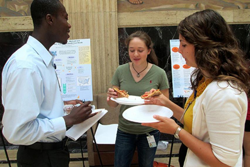 Student group eating pizza