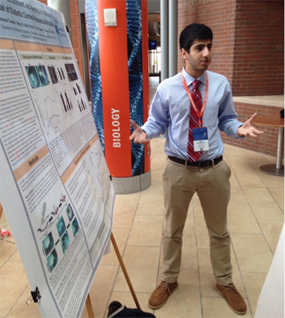 Student presenting poster to audience